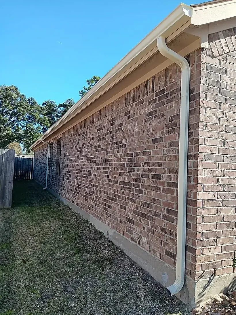 Long seamless gutter run along a brick wall
