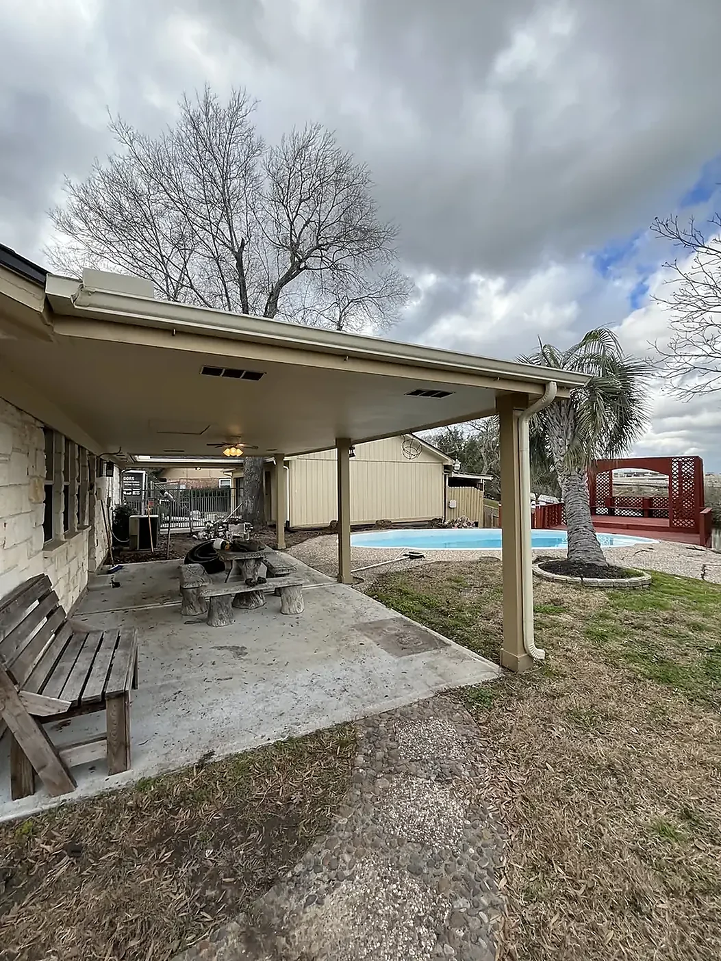 Covered patio roofline with gutter and drainage details
