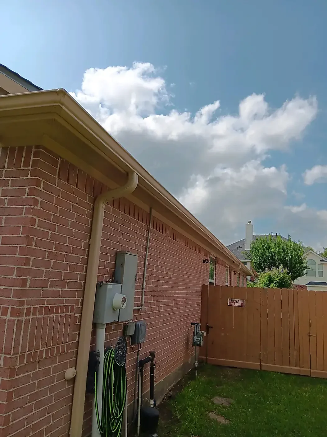 Brick home side wall with gutter and downspout