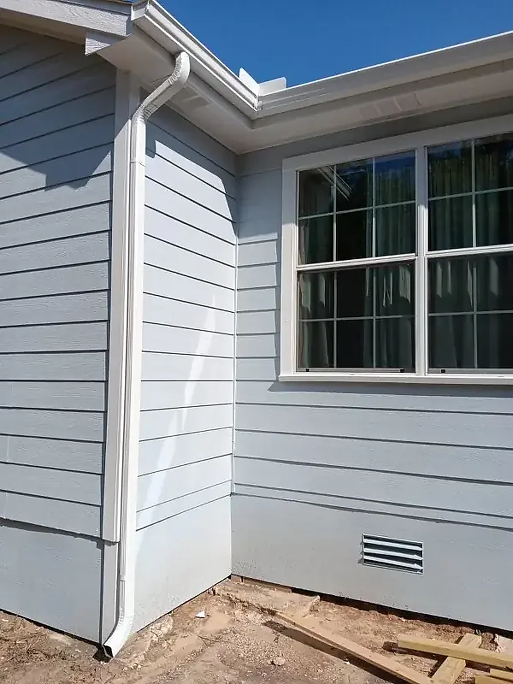 Siding corner showing a clean gutter and roofline transition