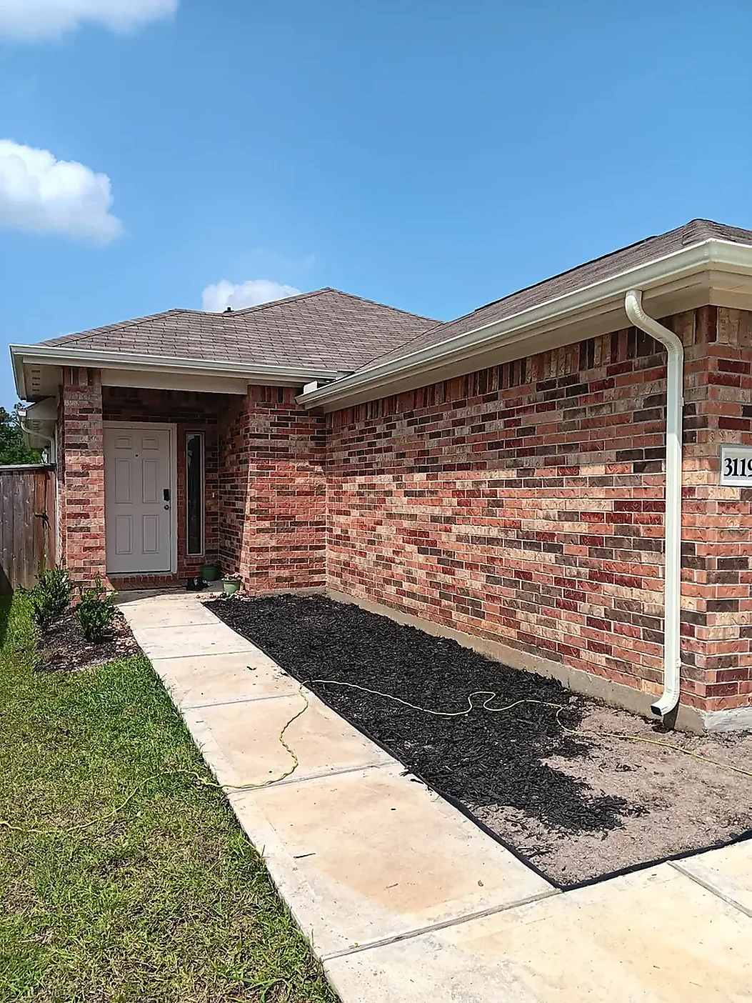Brick home roofline with a clean gutter layout