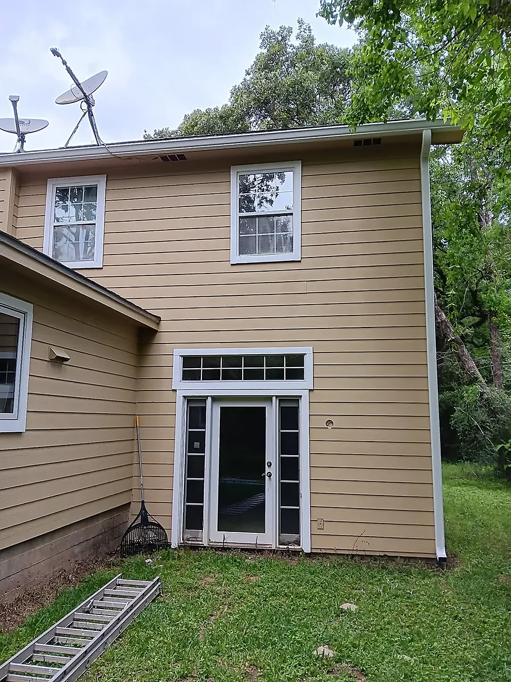 Two-story exterior with visible gutter and downspout paths