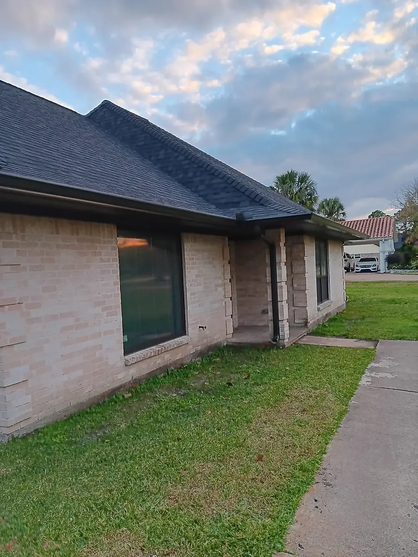 Brick home side roofline with a low gutter run