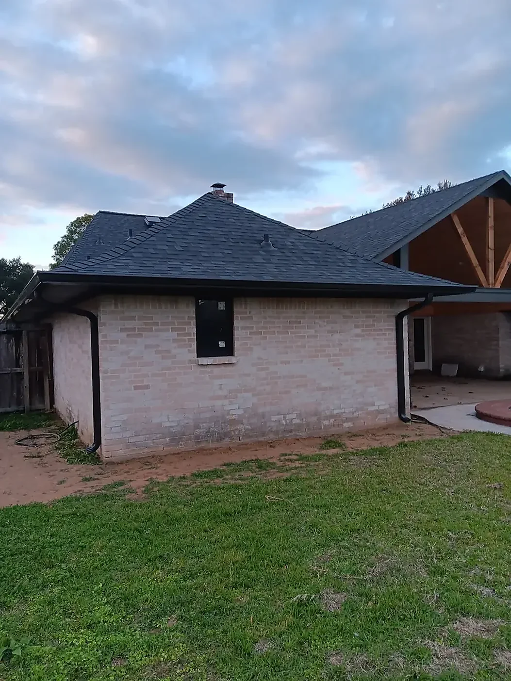 Dark-roof brick exterior with a defined gutter edge