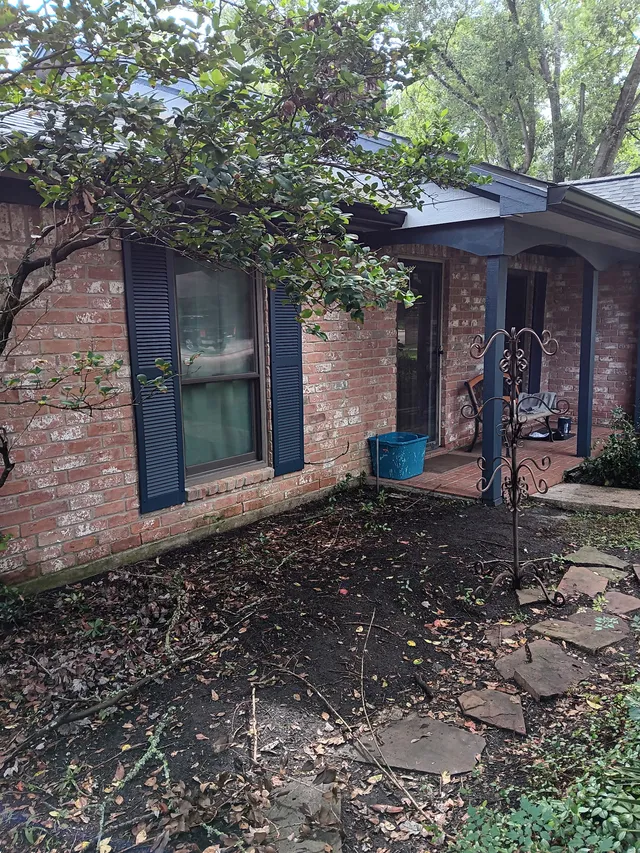 Dark gutters and downspouts around a brick exterior