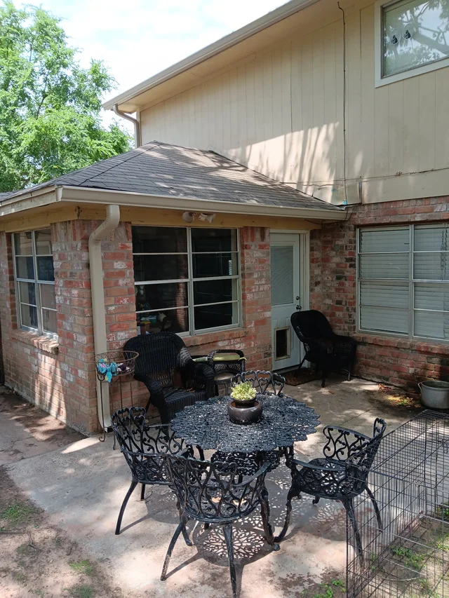 Gutter and downspout routing around a covered outdoor living area