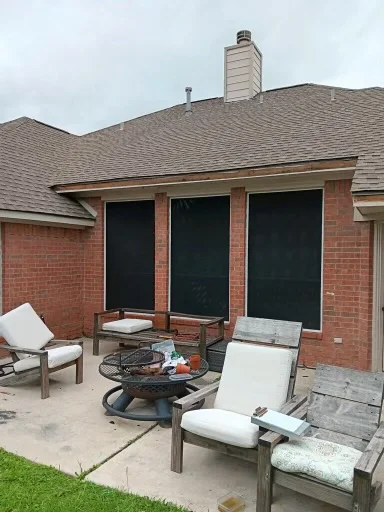 Pale gutter and downspout at the corner of a brick home
