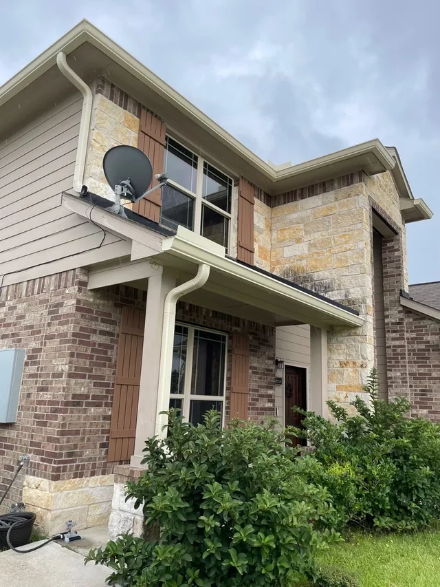 Gutters stepping around a two-story exterior