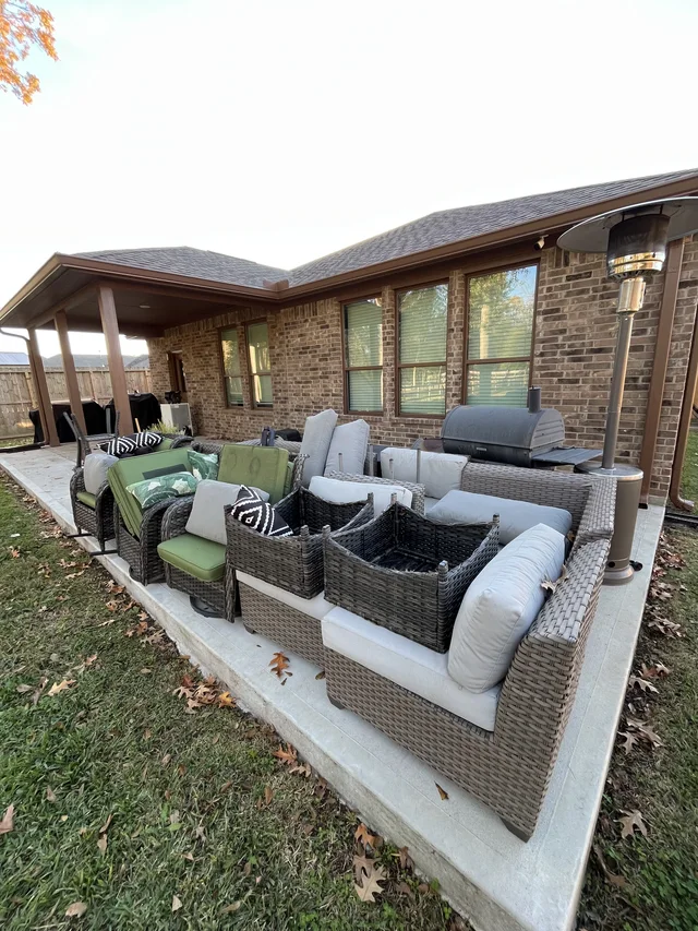 Gutter and downspout routing around a covered outdoor living area