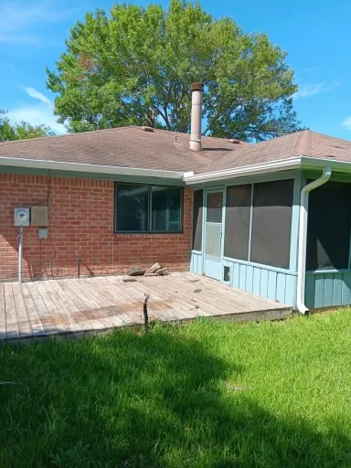 Dark gutter routing along a wood-sided home