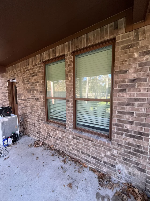 Gutter and downspout routing around a covered outdoor living area