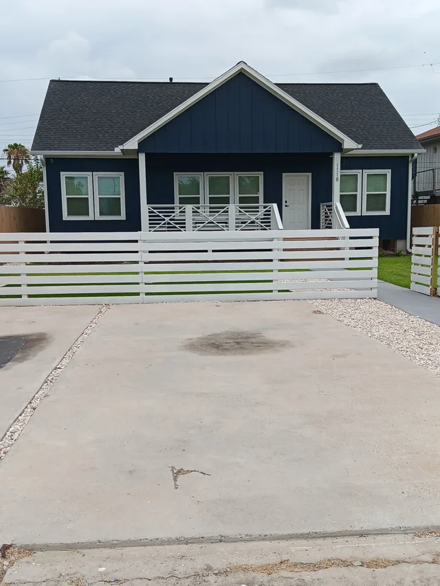 White gutters and downspouts against blue-gray siding