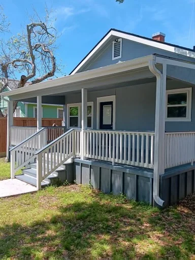 White gutters and downspouts against blue-gray siding