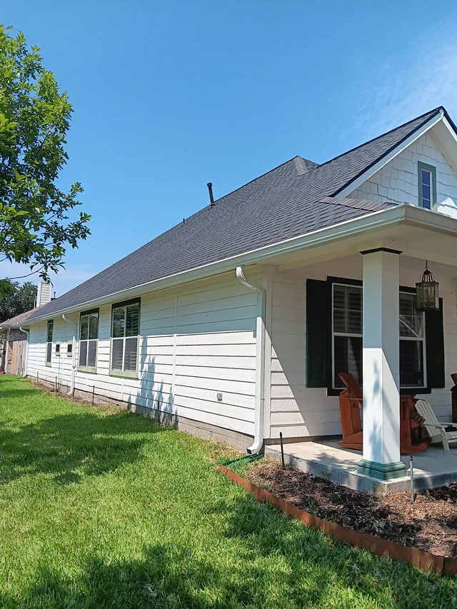 White gutters and downspouts against blue-gray siding