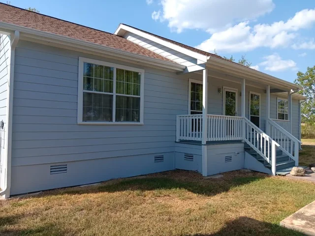 White gutters and downspouts against blue-gray siding