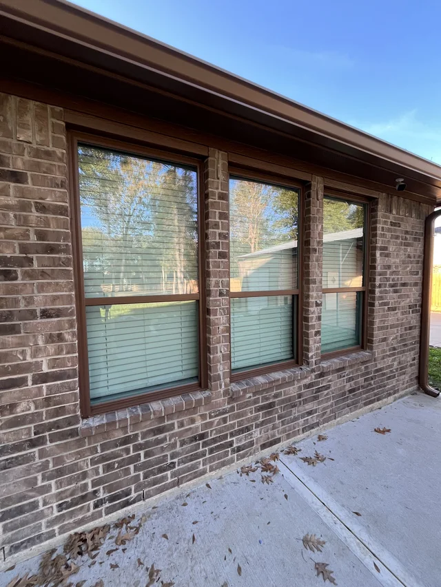Gutter and downspout routing around a covered outdoor living area