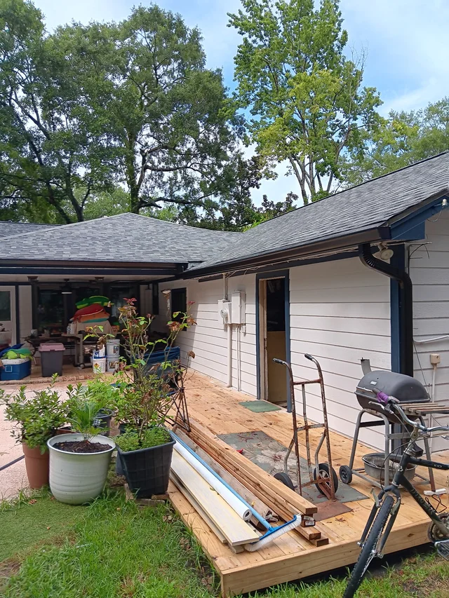 Dark gutters and downspouts around a brick exterior